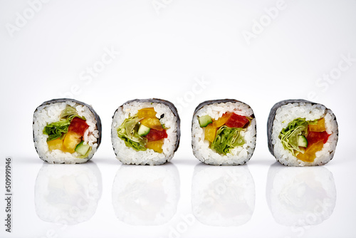 Vegetable sushi rolls isolated on a white background with shadow        