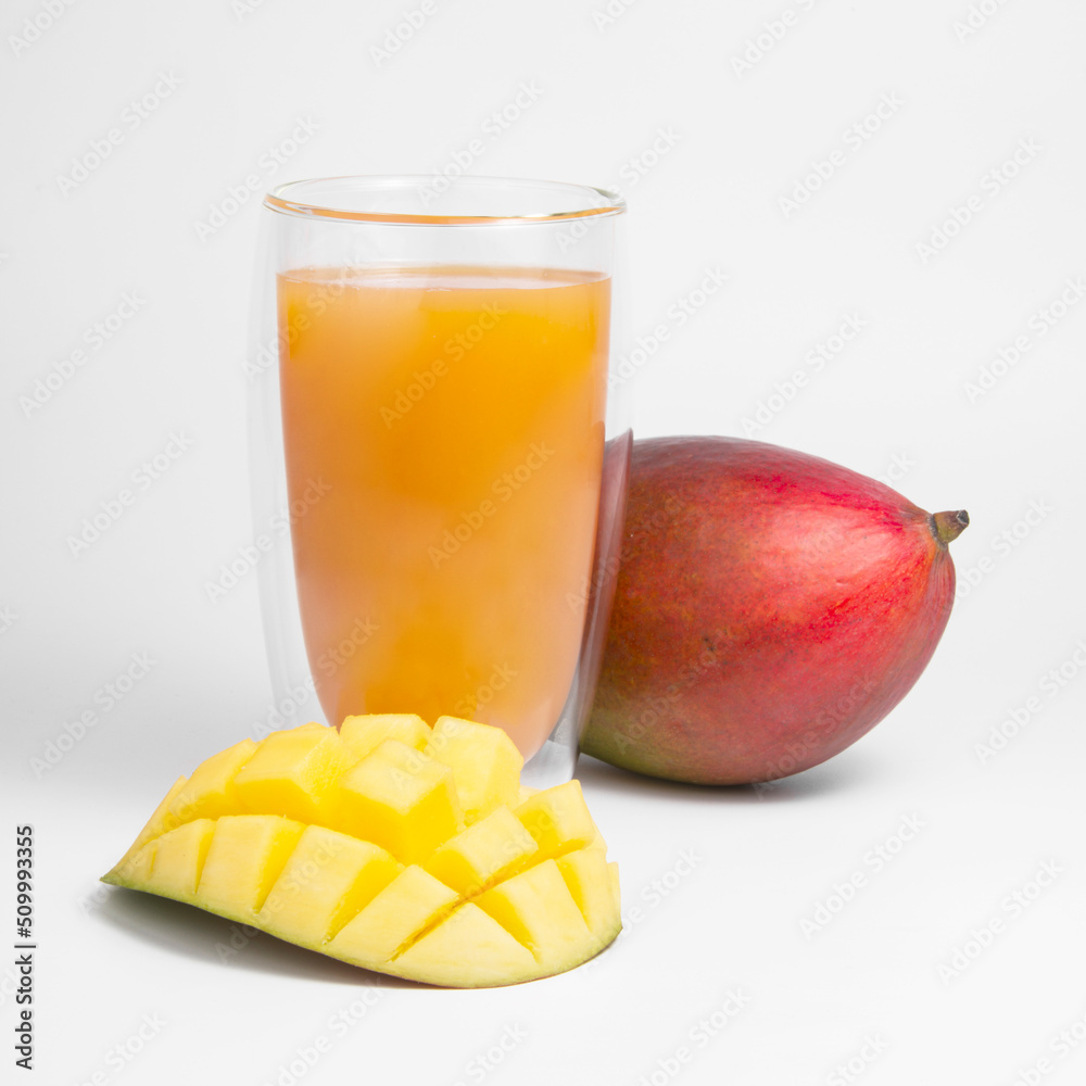 Mango fruit juice in glass isolated on the white Mango fruit juice in glass isolated on the white