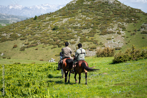 Group of horseback riders ride in Galicnik, North Macedonia photo