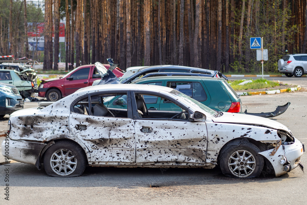 A car destroyed by shrapnel from a rocket that exploded nearby. Irpensky automobile cemetery. Consequences of the invasion of the Russian army in Ukraine. Destroyed civilian vehicle. A car destroyed by shrapnel from a rocket that exploded nearby. Irpensky automobile cemetery. Consequences of the invasion of the Russian army in Ukraine. Destroyed civilian vehicle.