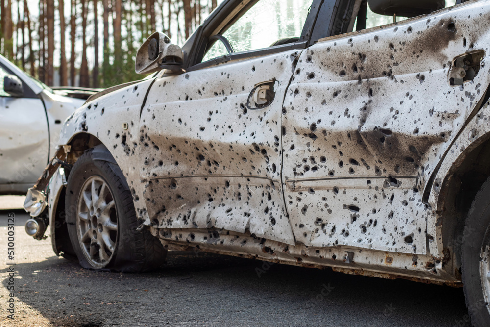 A car destroyed by shrapnel from a rocket that exploded nearby. Irpensky automobile cemetery. Consequences of the invasion of the Russian army in Ukraine. Destroyed civilian vehicle. A car destroyed by shrapnel from a rocket that exploded nearby. Irpensky automobile cemetery. Consequences of the invasion of the Russian army in Ukraine. Destroyed civilian vehicle.