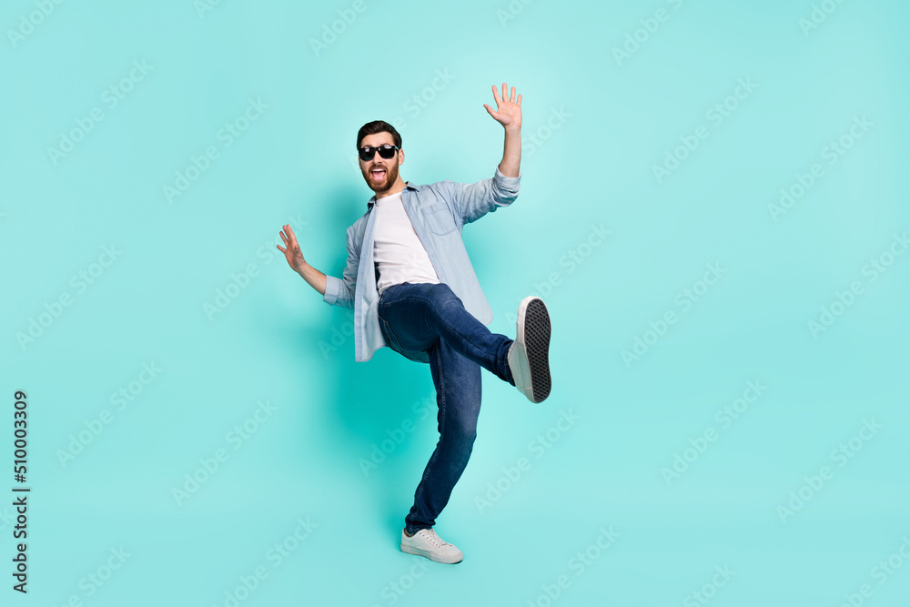 Photo of satisfied carefree person enjoy dancing clubbing free time isolated on turquoise color background