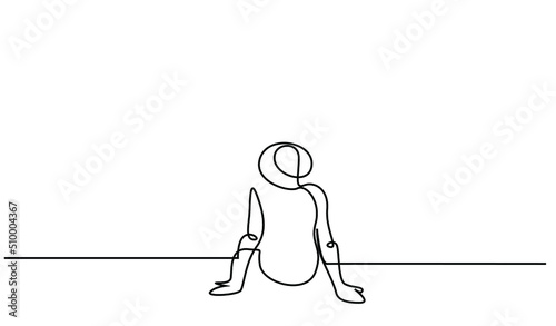 one young male sitting calmly on the floor with his back turned holiday hat