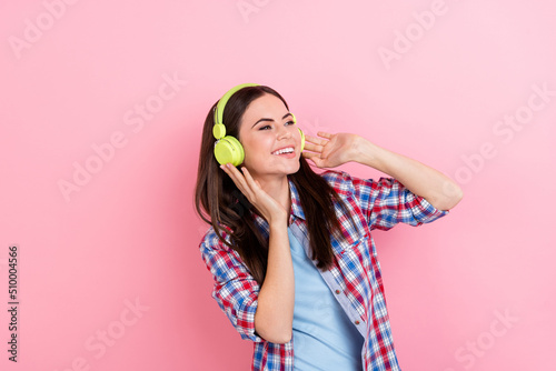 Photo of charming good mood girl relaxing on summer weekend visit club listen music isolated on pink color background