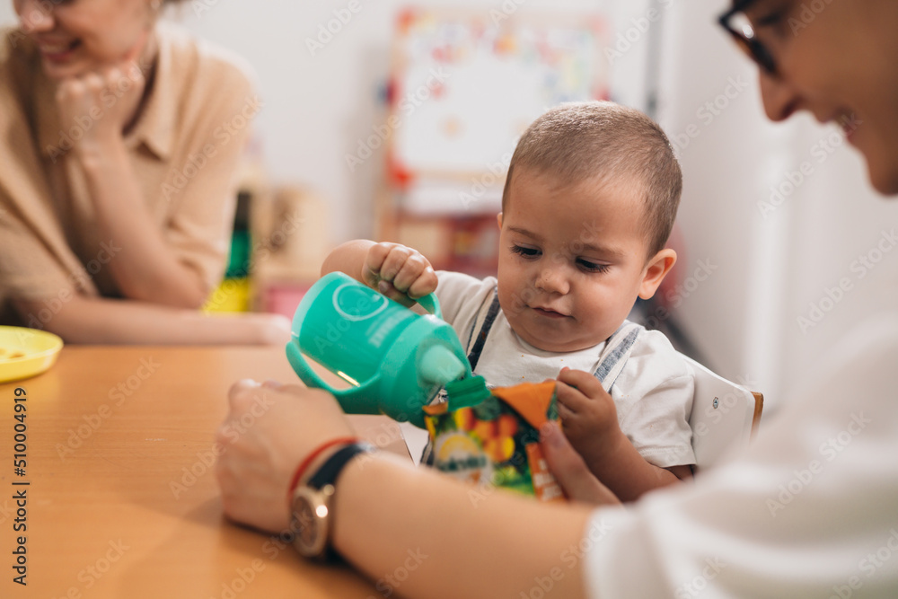 cute young baby boy breakfast in kindergarden cute young baby boy breakfast in kindergarden