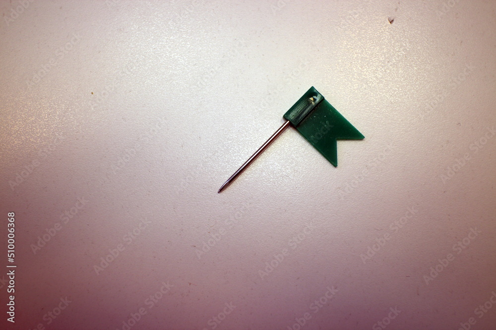 red flag with needles on the office table red flag with needles on the office table