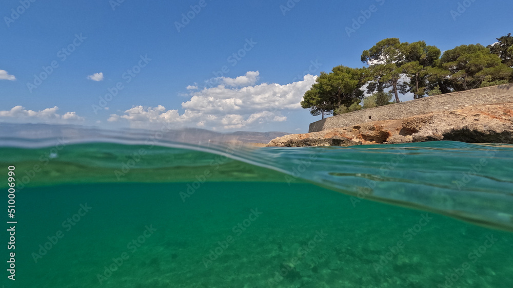 Underwater split photo of famous seaside area and forest of Kentri in picturesque village and port of Galaxidi, Fokida, Greece