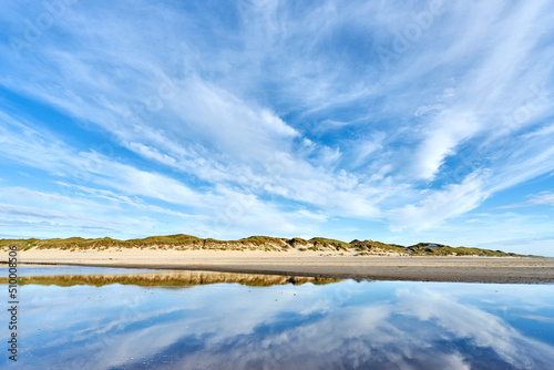 Beach and dunes on the Danish coastline with their reflection in the water © PeerOle