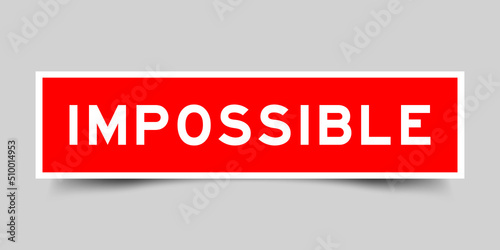 Sticker label with word impossible in red color on gray background