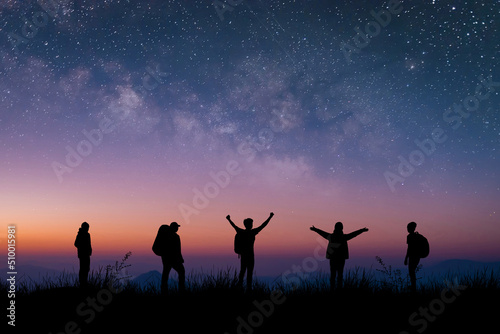 Silhouette group of young traveler and backpacker watched the star and milky way on top of the mountain with twilight sky. He enjoyed traveling and was successful when he reached the summit.