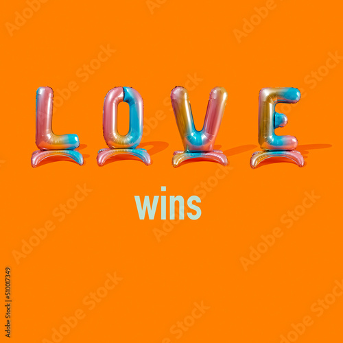 text love wins on an orange background