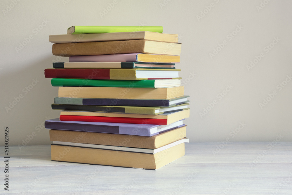 Stack of different colorful books on rustic table. Copy space Stack of different colorful books on rustic table. Copy space