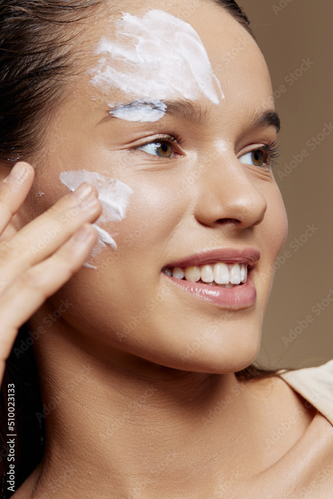 Young Woman face mask cream clean skin facial scrub close-up