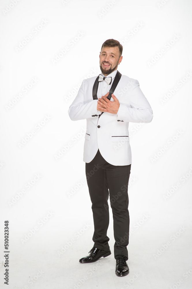 a kind man in a white jacket with a bow tie poses with positive emotions. cheerful man in the studio on a white background isolated shows a range of positive emotions a kind man in a white jacket with a bow tie poses with positive emotions. cheerful man in the studio on a white background isolated shows a range of positive emotions