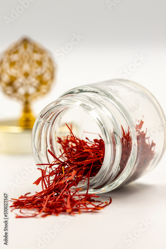 Packaged Iranian saffron in glass bottle on white background. close up
