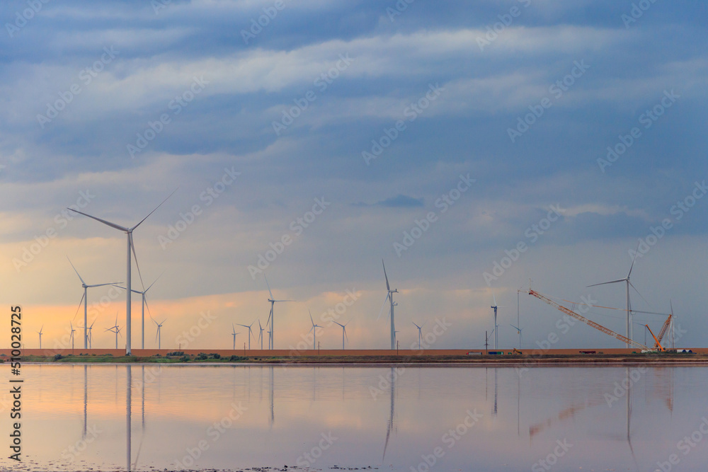Fototapeta premium Building and assembling a construction wind turbines farm by a crane