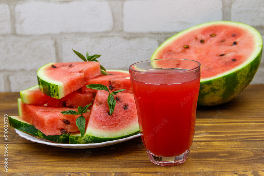 Glass of fresh watermelon juice on a wooden table Glass of fresh watermelon juice on a wooden table
