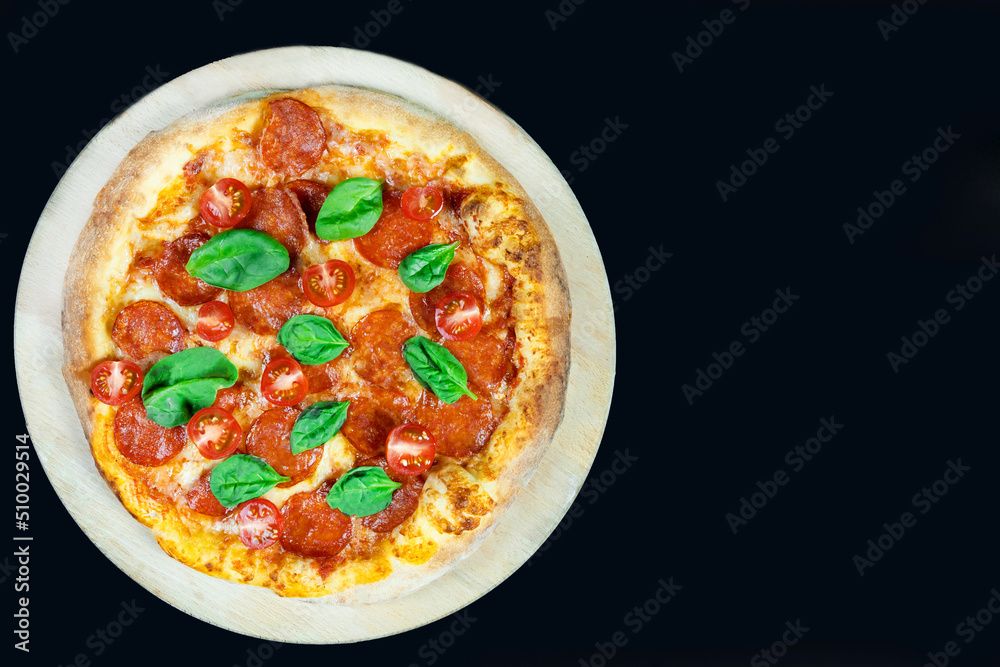 Pepperoni pizza with fresh tomatoes on a dark background, top view Pepperoni pizza with fresh tomatoes on a dark background, top view