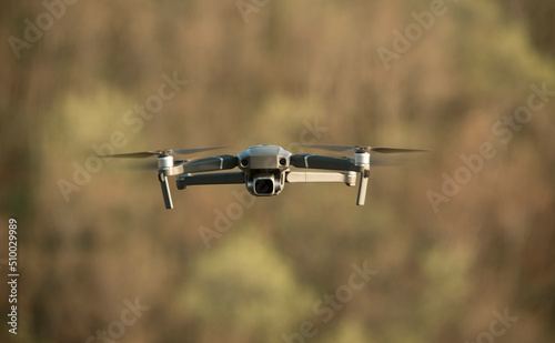 Quadcopter with a camera in flight. Technique for aerial photography