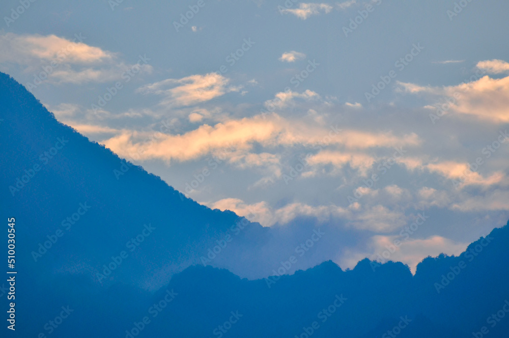 clouds over the mountains in sunset