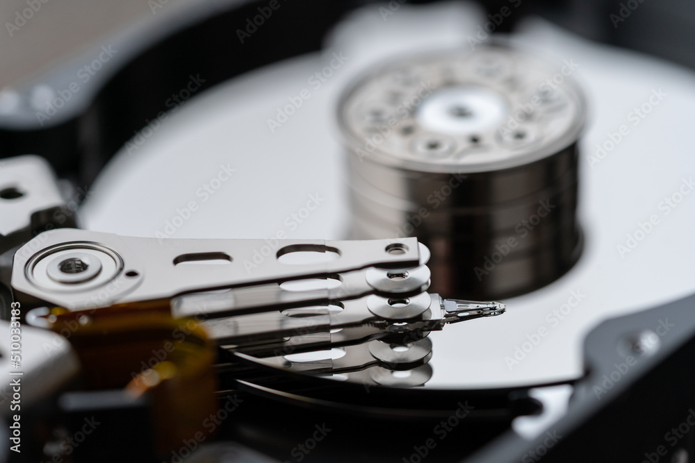 Opened hard disk after disassembly during repair or service, macro shot. Computer HDD inside, selective soft focus. Laptop or PC storage memory Opened hard disk after disassembly during repair or service, macro shot. Computer HDD inside, selective soft focus. Laptop or PC storage memory