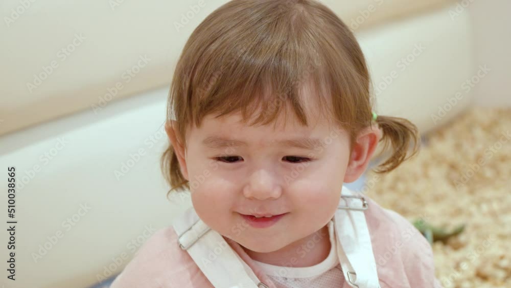 Charming And Lovely Face Of A Little Girl Smiling In Front Of Camera. Close Up Shot Charming And Lovely Face Of A Little Girl Smiling In Front Of Camera. Close Up Shot