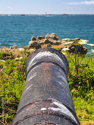 View down a cannon barrel at the L'Eree Battery, overlooking Les Hanois Lighthouse, Guernsey, Channel Islands photo