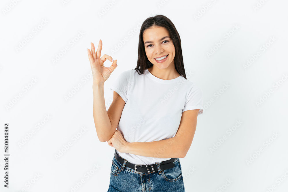 Cheerful confident woman wearing white T-shirt and blue jeans Cheerful confident woman wearing white T-shirt and blue jeans