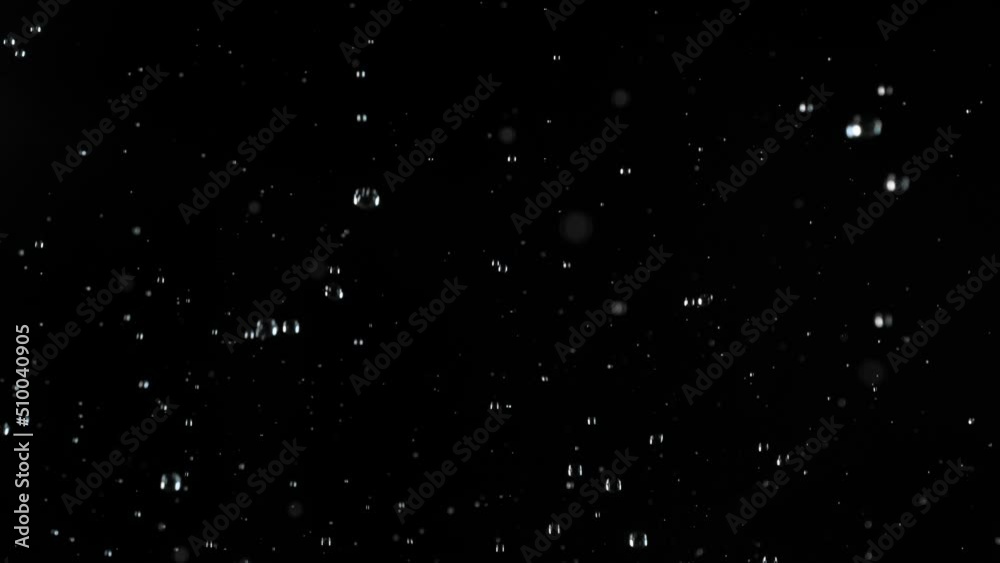 Super slow motion of realistic rain shower on black background. Filmed on high speed cinema camera, 1000 fps.