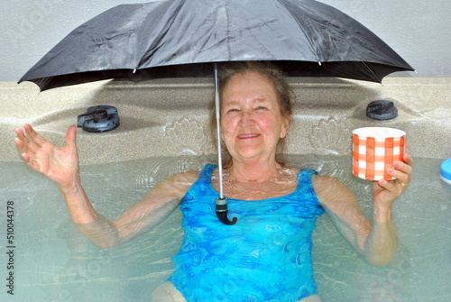Mature female senior enjoying her hot tub at home.