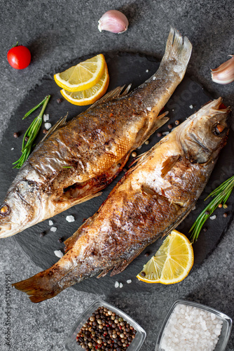 Baked sea bass fish on a stone background