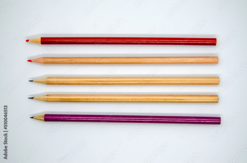 Set of colorful long pencils on white background. Top view, isolated wooden, red and purple pencils. Set of colorful long pencils on white background. Top view, isolated wooden, red and purple pencils.