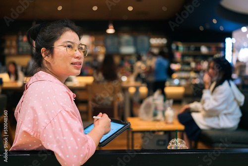 relax leisure attractive smart asian female freelance entrepreneur smile and enjoy working with smartphone and laptop tablet at cafe restaurant digital nomad expat casual ideas work anywhere concept photo