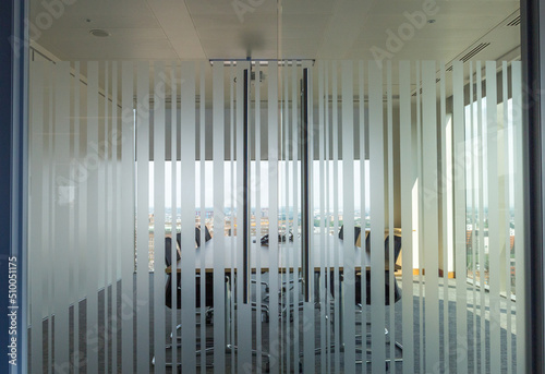 A modern meeting room with frosted privacy stripes