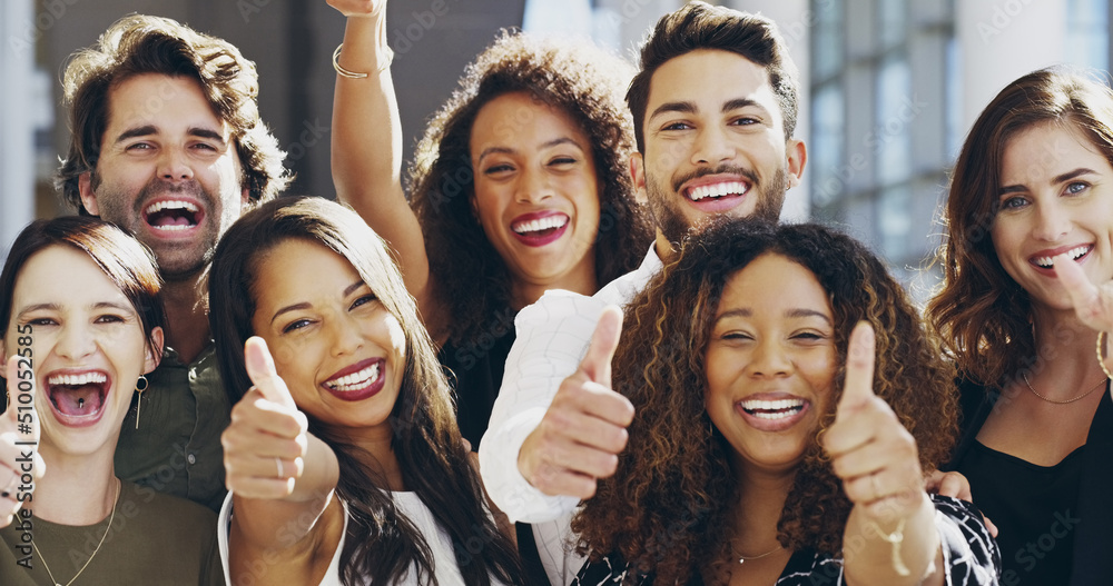 Obraz premium Cropped shot of a group of businesspeople giving thumbs up while standing in their office