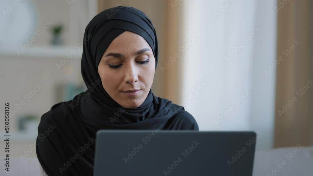 Focused ethnic female muslim arabian young woman girl islamic student businesswoman freelancer sits at home work on computer online chat search information data analyze develop web design e-commerce Focused ethnic female muslim arabian young woman girl islamic student businesswoman freelancer sits at home work on computer online chat search information data analyze develop web design e-commerce