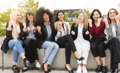 portrait multiracial business women happy, winning, celebration gesture, outdoors photo