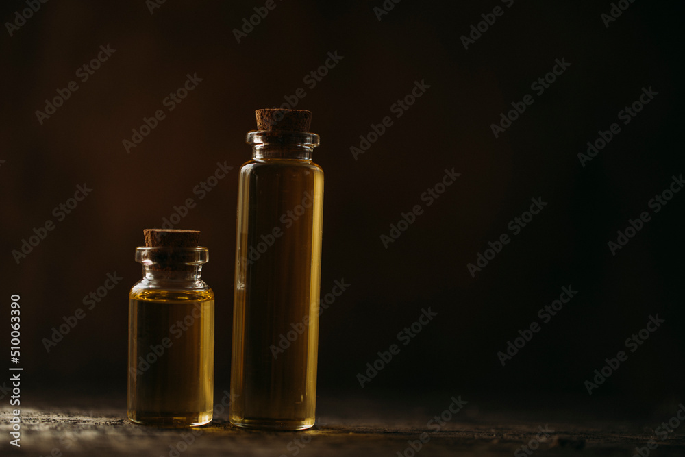 oil and flowers. Oil bottle. Spa concept. Spa. Glass. Wellness. Cosmetic. Photo. Background. Flowers. 