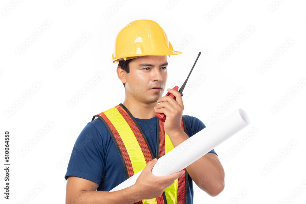 Fototapeta premium Construction handsome man worker in yellow helmet and reflective vest and using walkie talkie for talking with team staff isolated on white background.