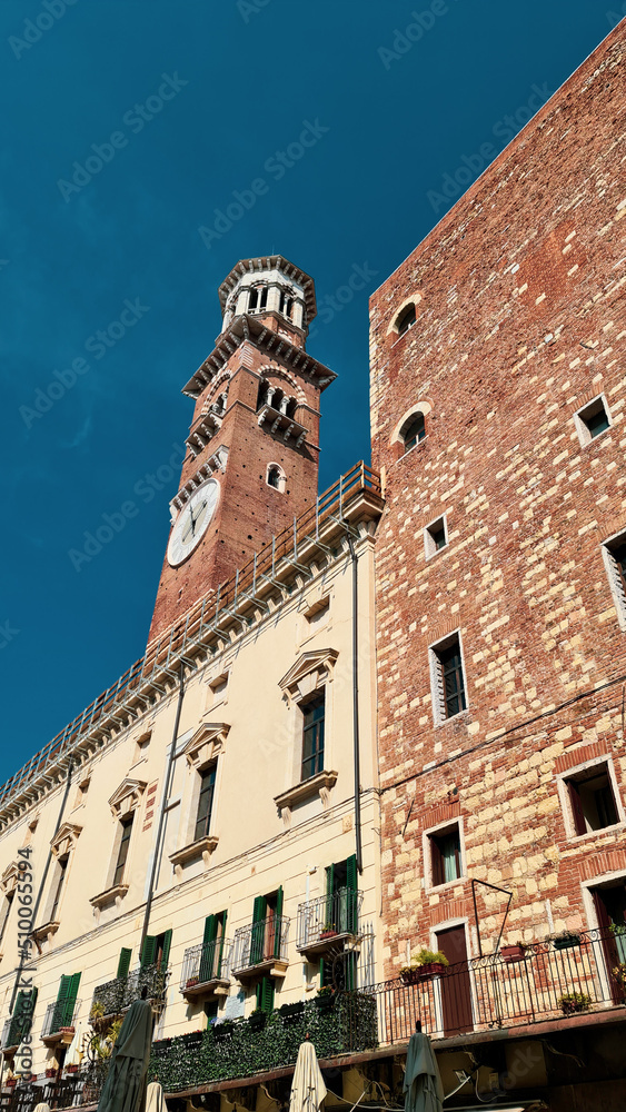 Verona, Italy-March 19, 2022: Beautifull old buildings of Verona. typical architecture of the medieval period. Aerial view to the city with blue sky in the background, beautiful view to adige river.