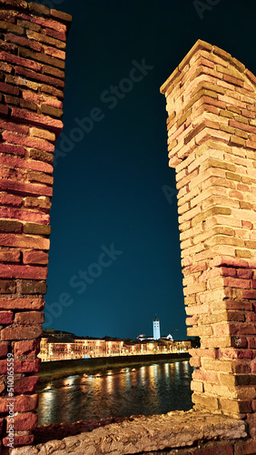 Verona, Italy-March 19, 2022: Beautifull old buildings of Verona. typical architecture of the medieval period. Aerial view to the city with blue sky in the background, beautiful view to adige river.