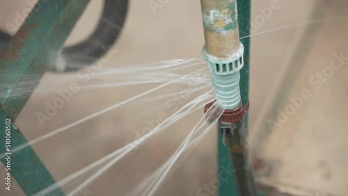 Jets of water spread in different directions from a broken, cracked pipe.