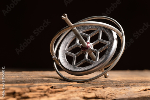 Close up of cast aluminum gyroscope gyro kids toy that children play with. photo