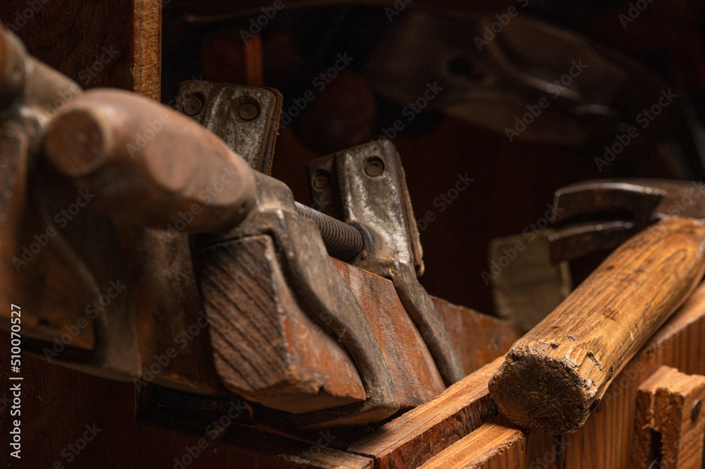 Collection of various antique wood working tools and hand tools in vintage wooden carpenter's tool box