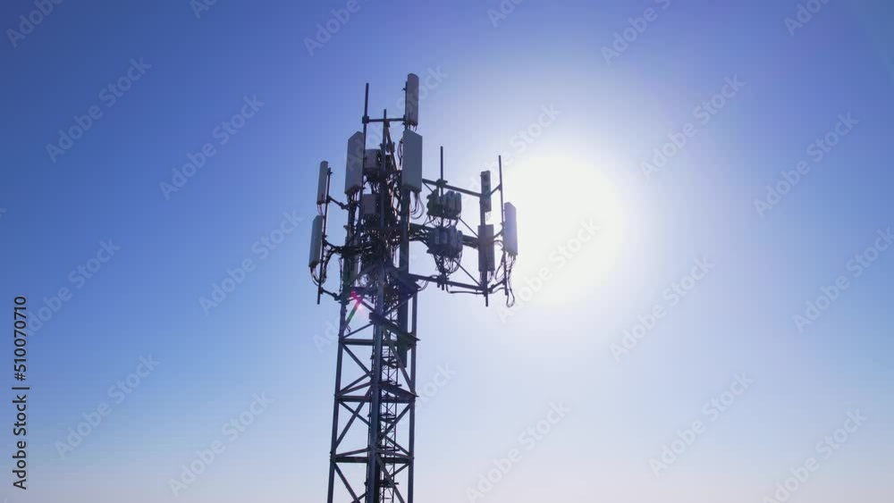 Telecommunication tower for signal broadcasting, antennas for gsm, 3g, 4g and 5g cellular networks and mobile data. Around view at golden hour evening with sun leaks. Telephony and internet connection Telecommunication tower for signal broadcasting, antennas for gsm, 3g, 4g and 5g cellular networks and mobile data. Around view at golden hour evening with sun leaks. Telephony and internet connection