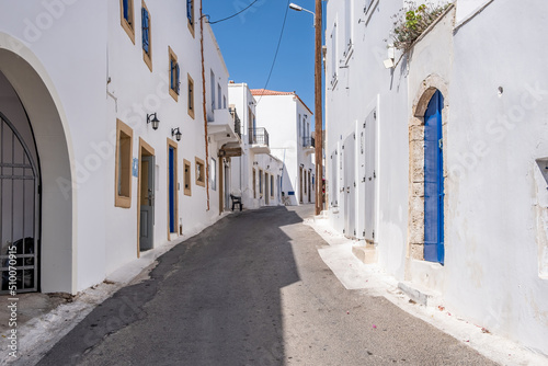 Fototapeta Naklejka Na Ścianę i Meble -  Greece, Kythira island. Empty narrow street at Chora town. Traditional white color wall building