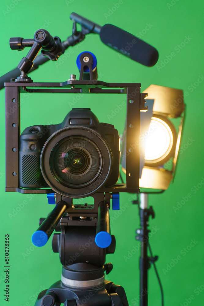 camera,microphone, lights and a green screen camera,microphone, lights and a green screen