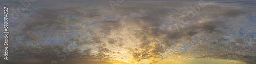 Panorama of a dark blue sunset sky with golden Cumulus clouds. Seamless hdr 360 panorama in spherical equiangular format. Full zenith for 3D visualization, sky replacement for aerial drone panoramas. © svetograph