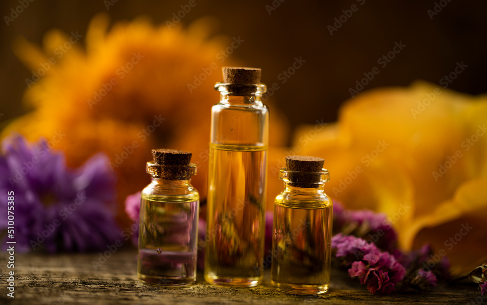 bottle of oil with flowers. Oil bottle. Glass. Nature. Beauty. Spa concept. Essential. 