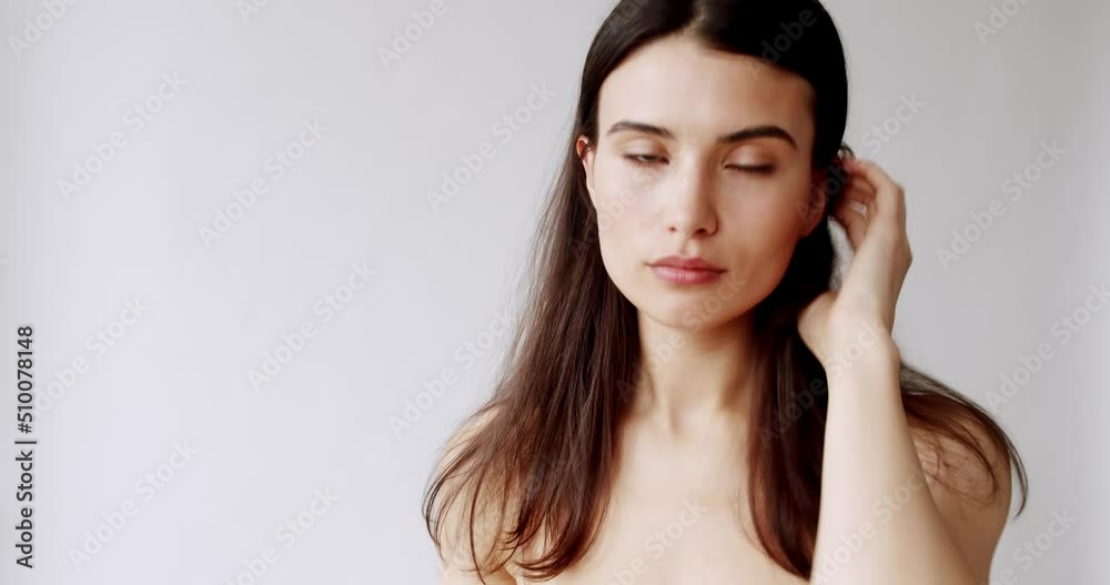 Close-up portrait of a young luxurious sexy woman looking at the camera on a white background indoors. Face of professional fashion model, make-up miss with brown eyes. Skincare treatment, cosmetics Close-up portrait of a young luxurious sexy woman looking at the camera on a white background indoors. Face of professional fashion model, make-up miss with brown eyes. Skincare treatment, cosmetics